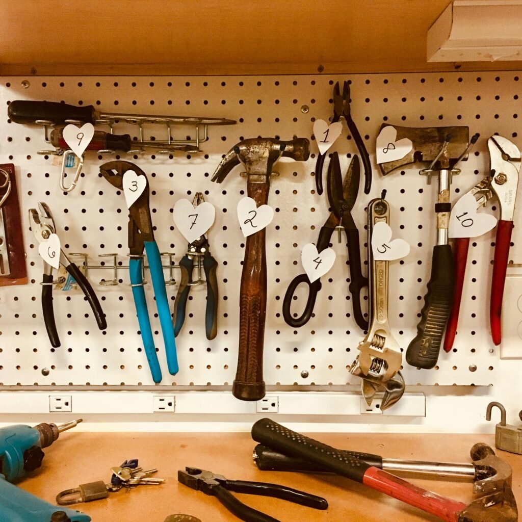 pexels-photo-909256-909256 Neatly arranged tools on a pegboard in a well-lit workshop setting.